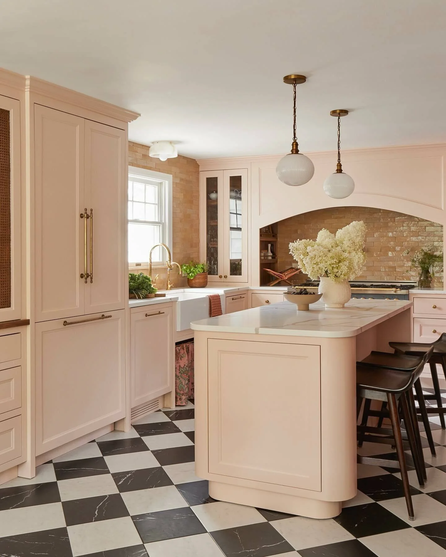 Rounded Island Base Softens Pink Kitchen Lines