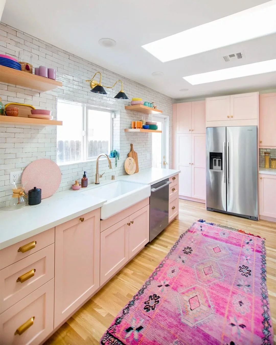 Open Shelving Displays Colorful Dishware Above White Brick Backsplash