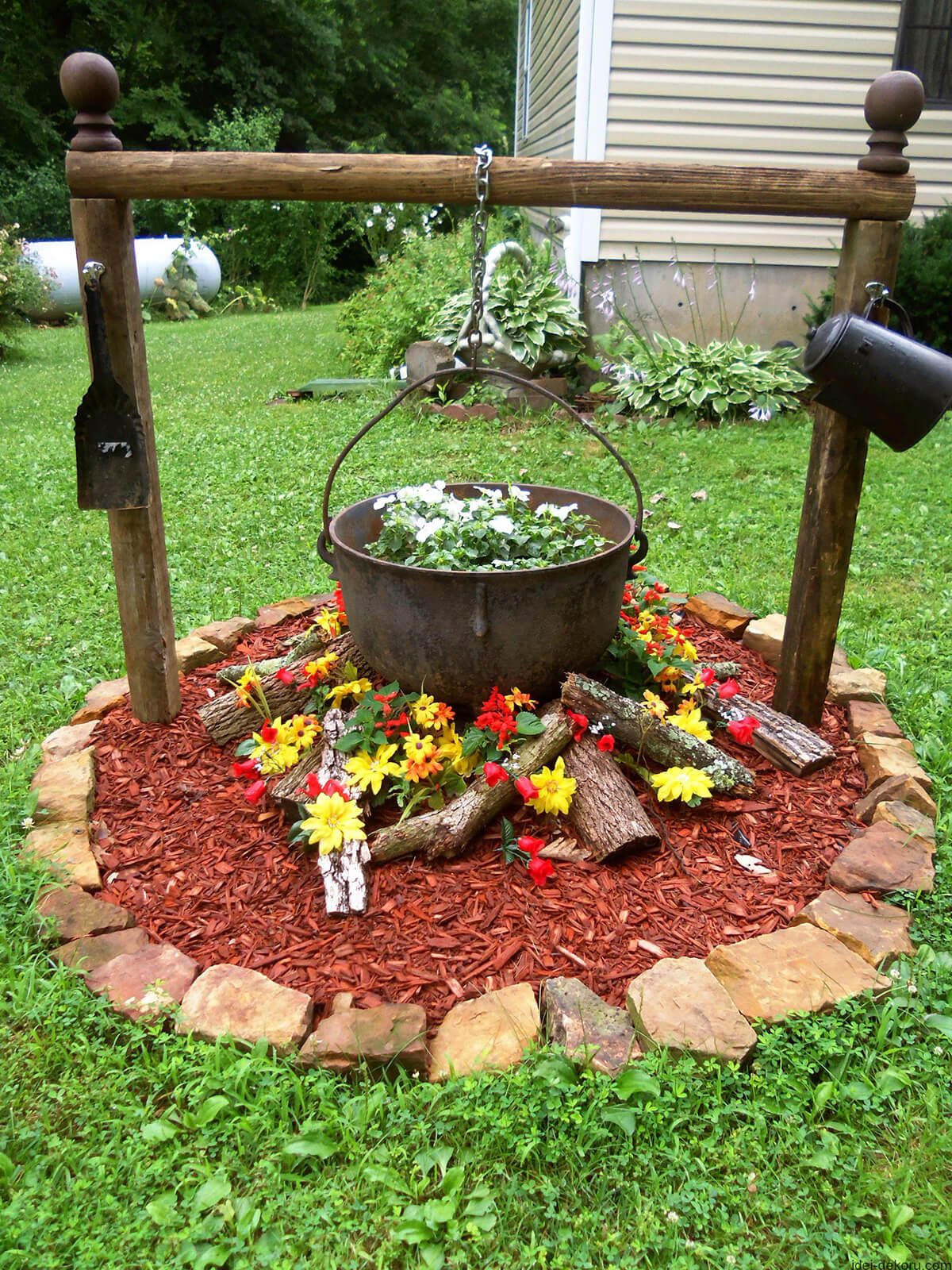 Cast Iron Cauldron Becomes a Rustic Flower Bed Centerpiece