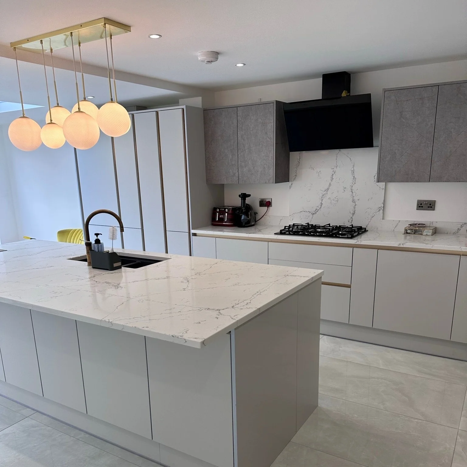Orb Pendant Lights Create a Warm Glow Above the Island