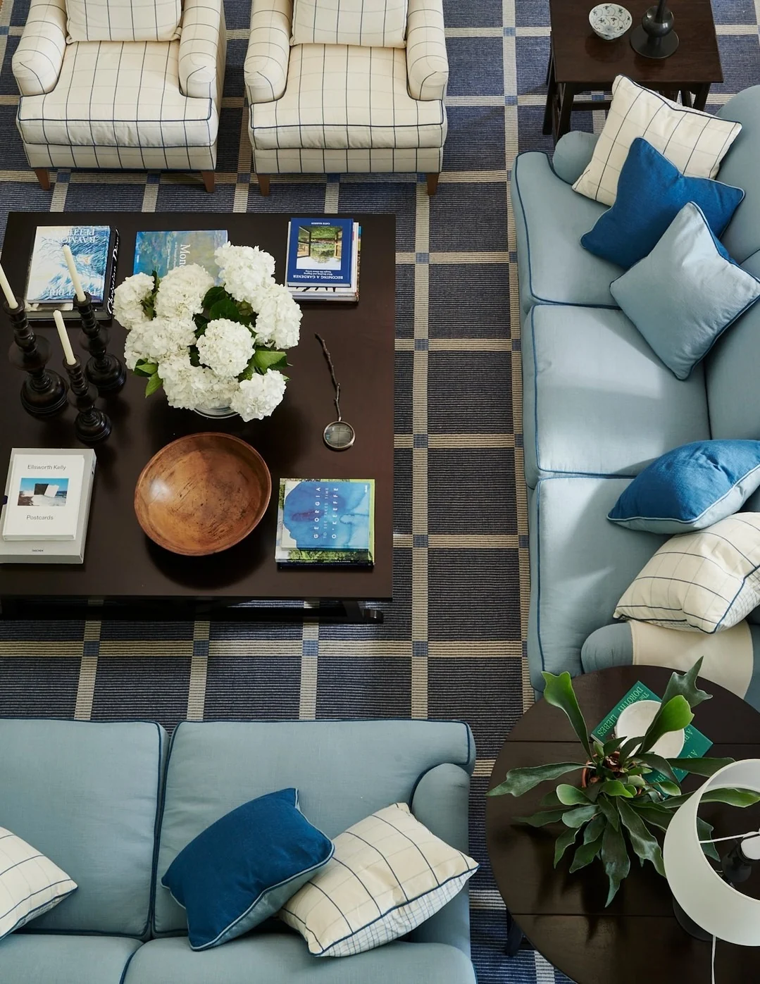 Checkerboard Rugs Frame Seating Areas in Blue and Cream