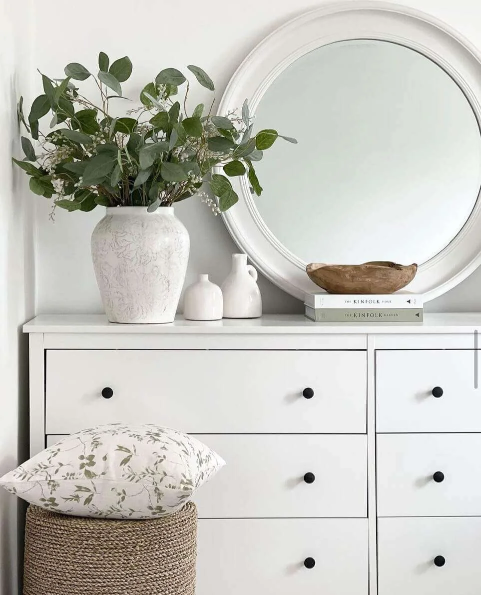White Dresser Features a Textured Vase of Eucalyptus