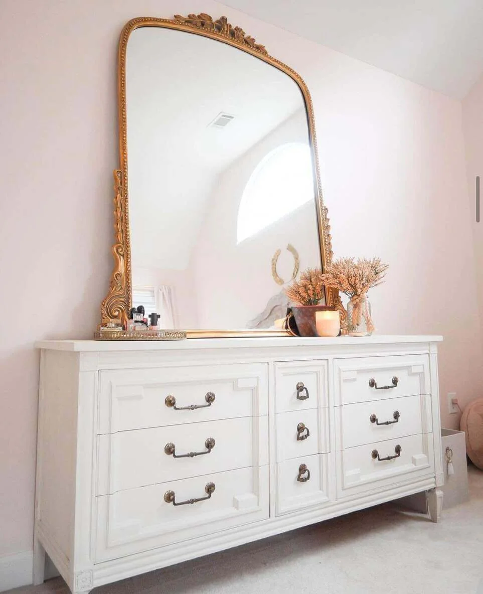 Ornate Gold Mirror Adds Grandeur Above a White Dresser