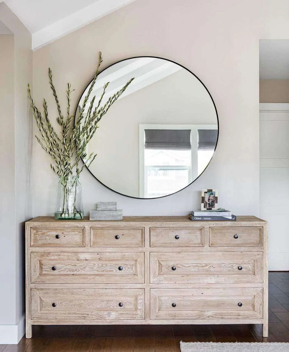 Large Round Mirror Creates a Dramatic Focal Point