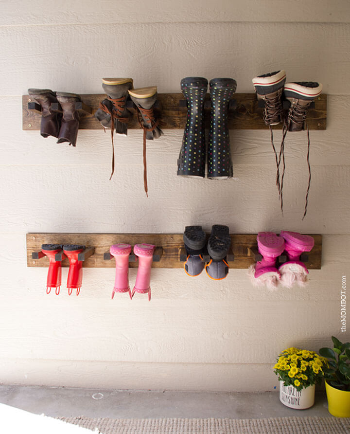 Wooden Planks With Hooks Suspend Boots Off the Floor