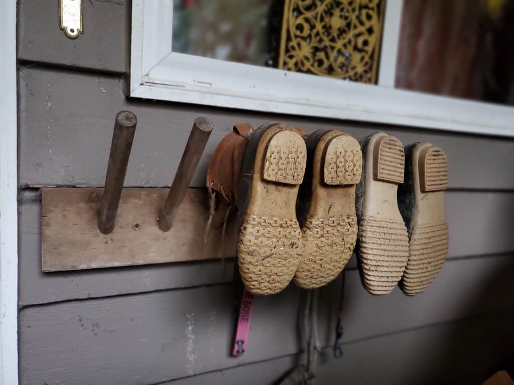 Wooden Pegs on a Plank Hang Boots Off the Ground