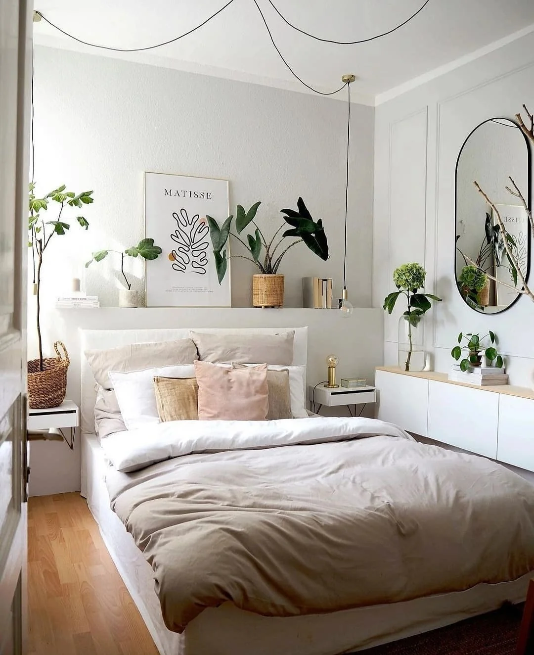 Floating bedside shelves hold plants and art