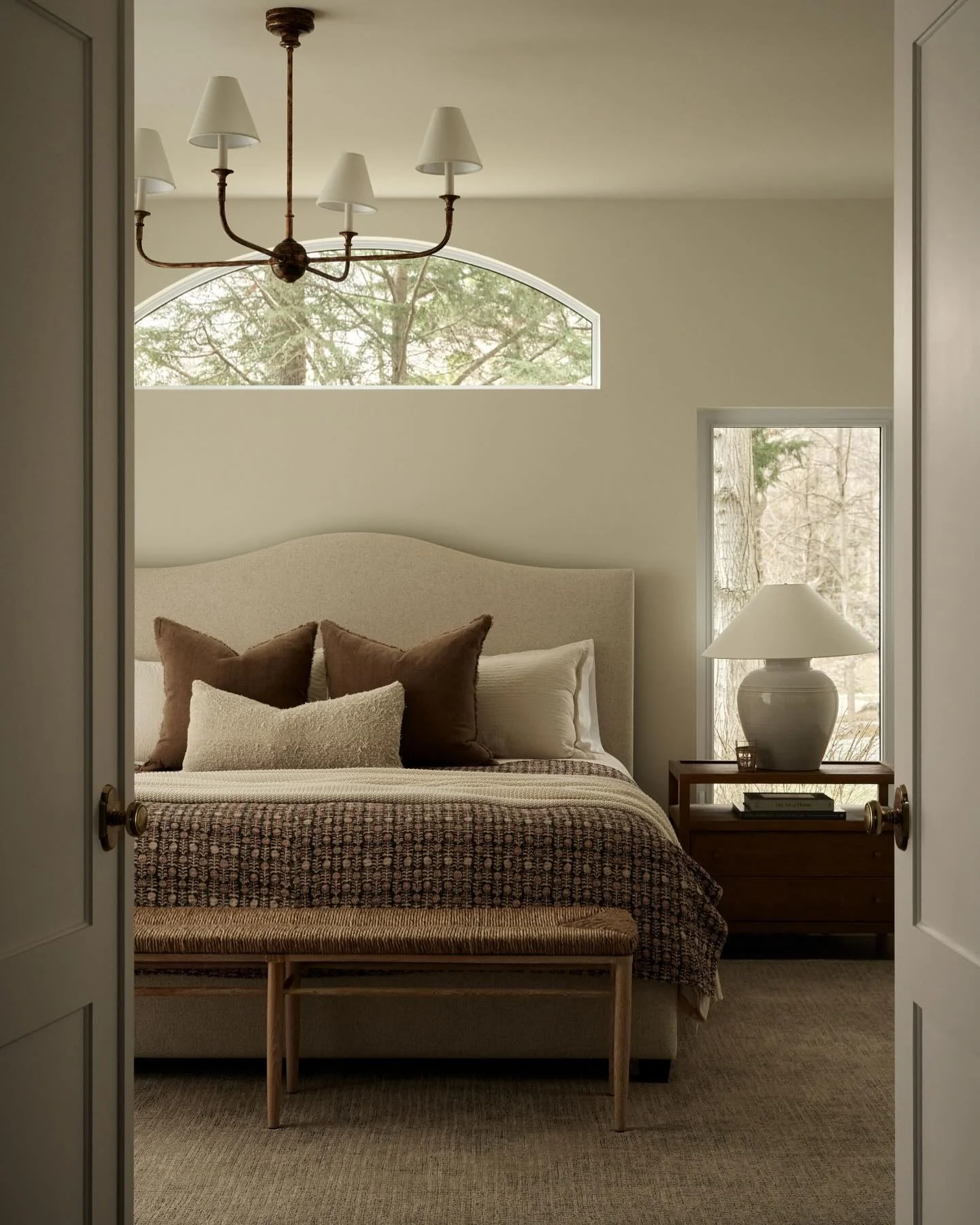 Woven Rattan Bench Adds Natural Texture at Foot of Bed