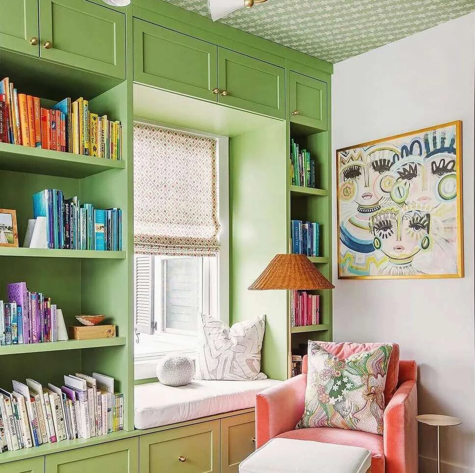 Green Built-In Shelving Frames a Cozy Window Seat