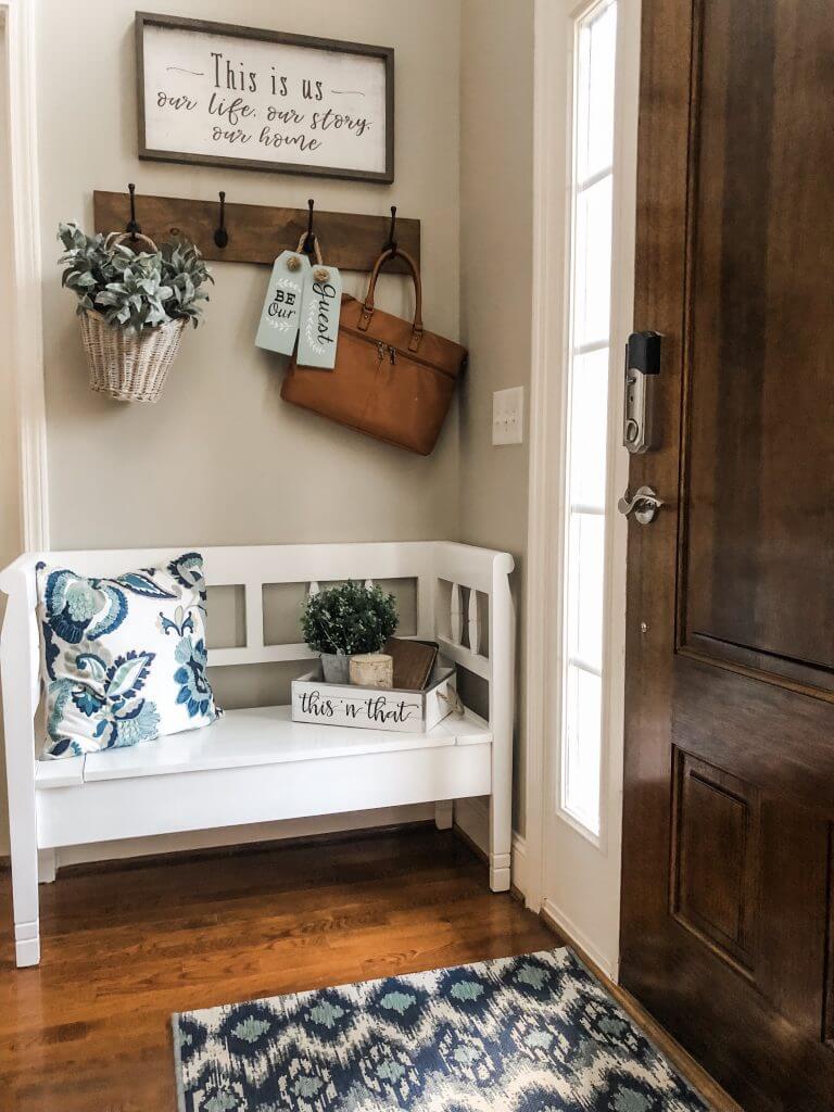 White Storage Bench With Blue and White Patterned Pillow