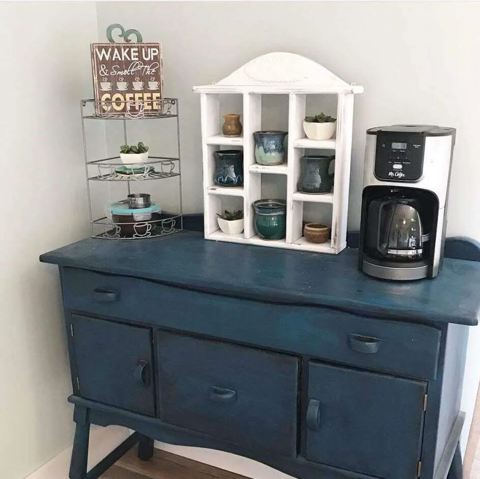 White tiered cubby shelf displays small plants and mugs