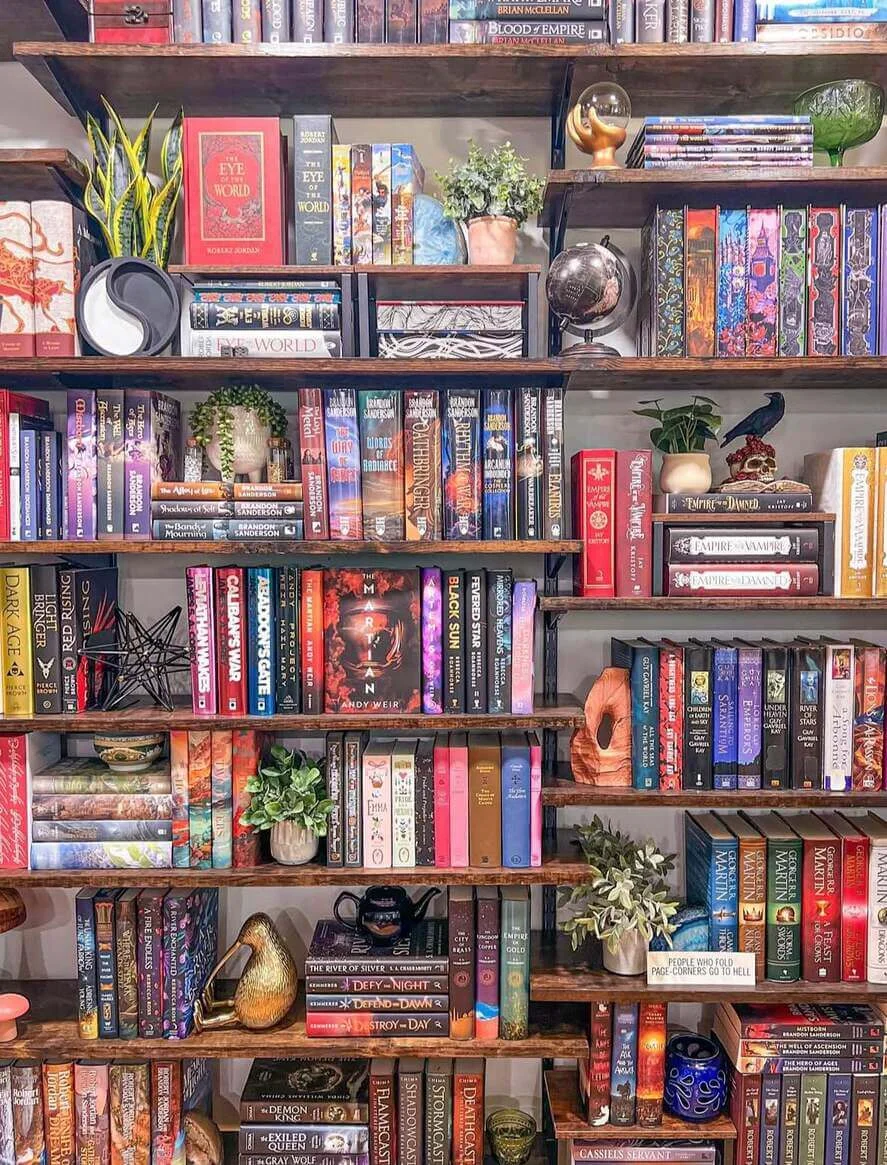Decorative Objects Add Personality Between Book Stacks