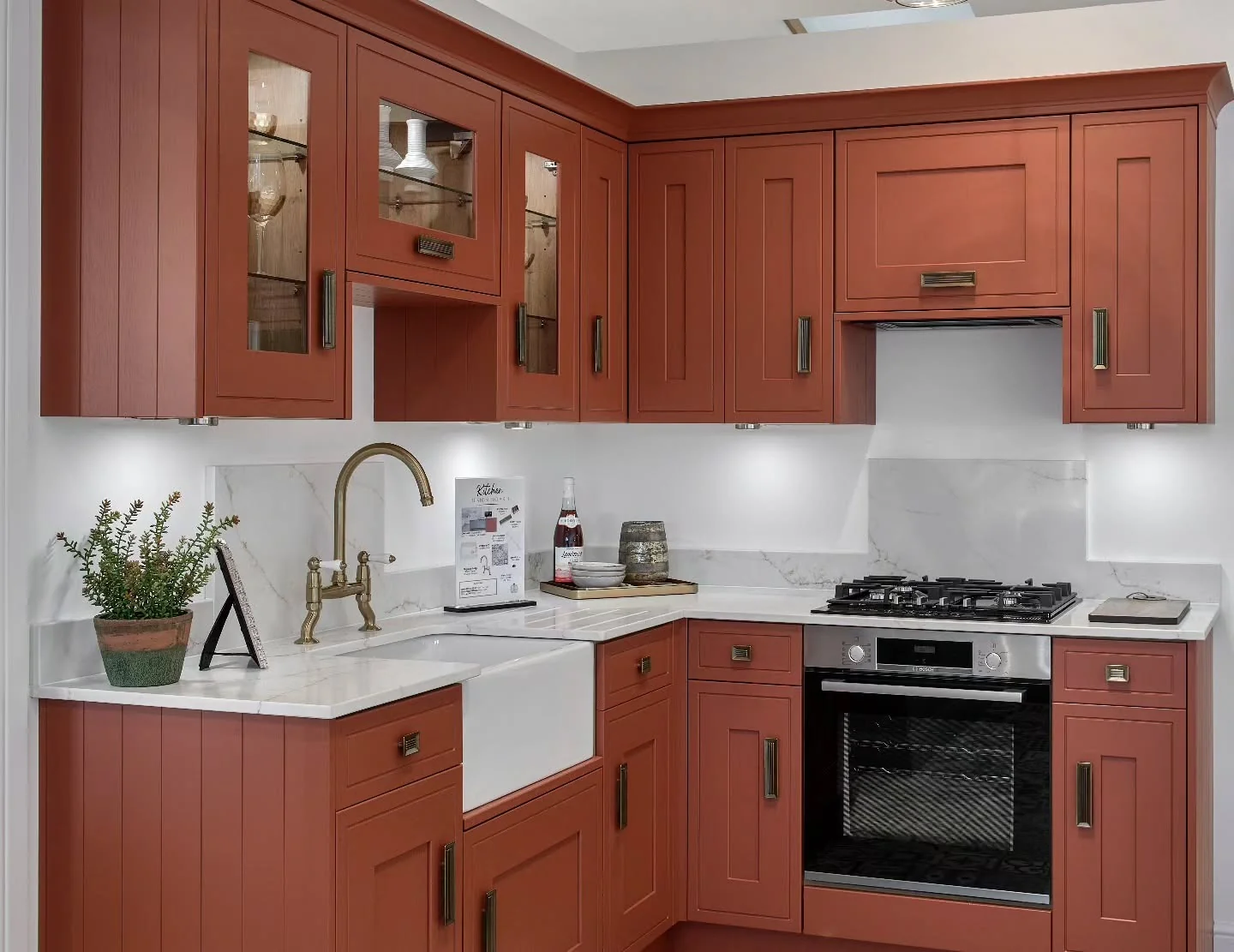 Vintage Charm: Red Shaker Cabinets with Aged Brass Bin Pulls