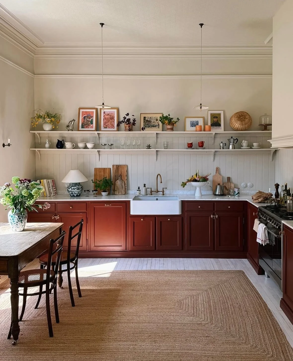 Ground Your Workspace with Deep Red Cabinets Framing a White Farmhouse Sink