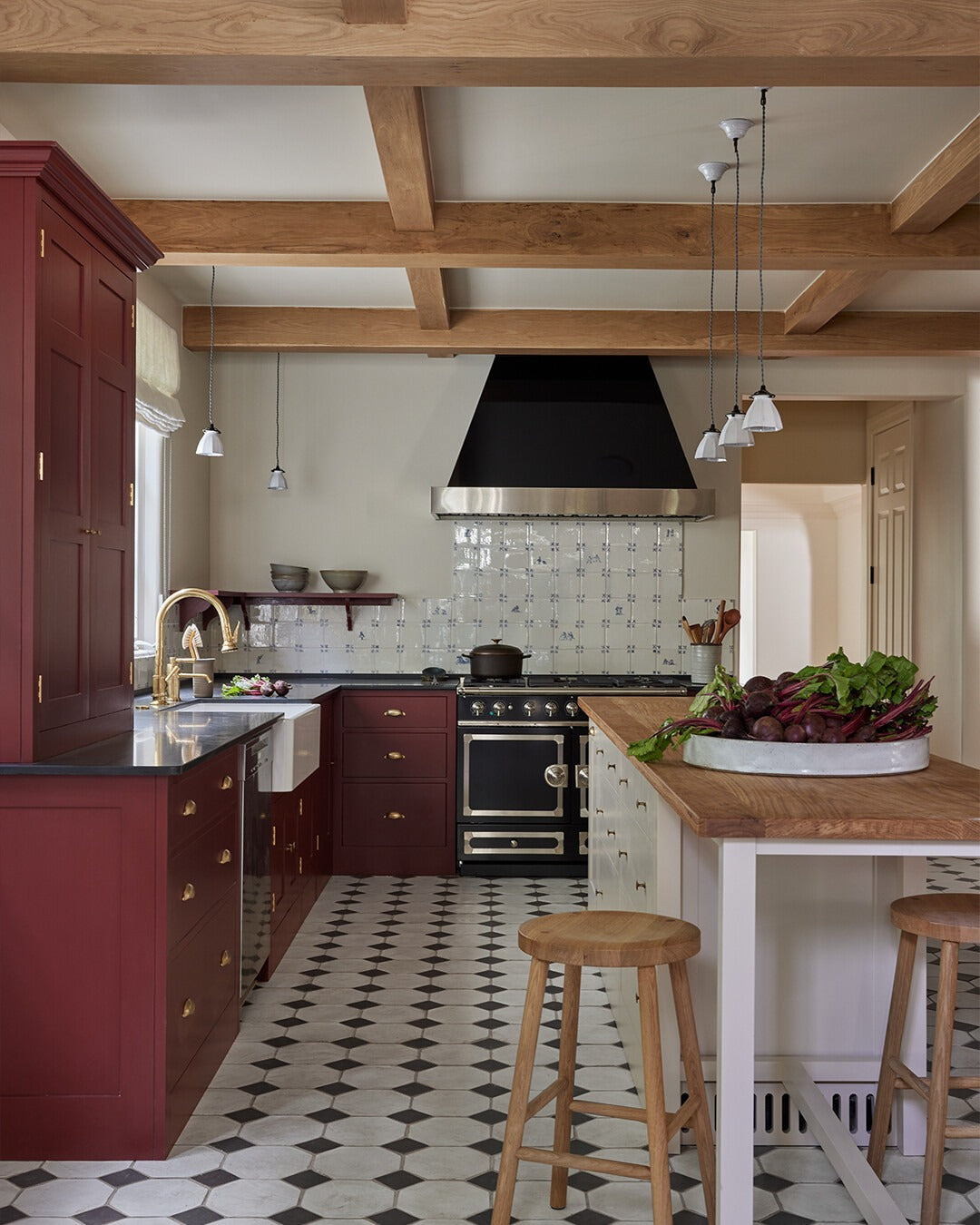 Classic Boldness: Deep Red Cabinets with Rounded Brass Drawer Pulls