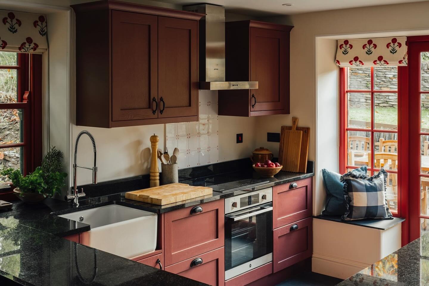 Deep Red Cabinetry With Contrasting Black Hardware