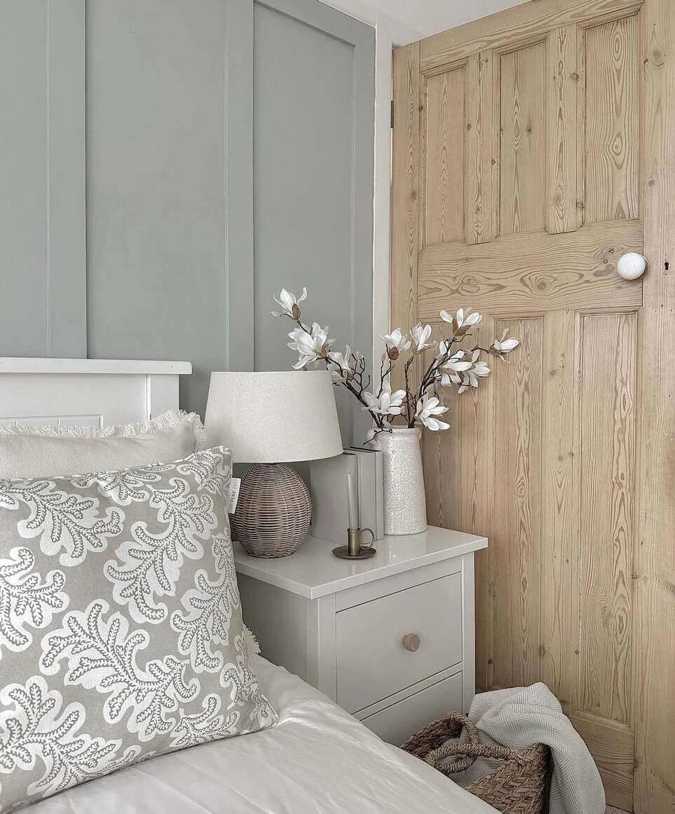 White magnolia branches add a delicate touch to bedside decor