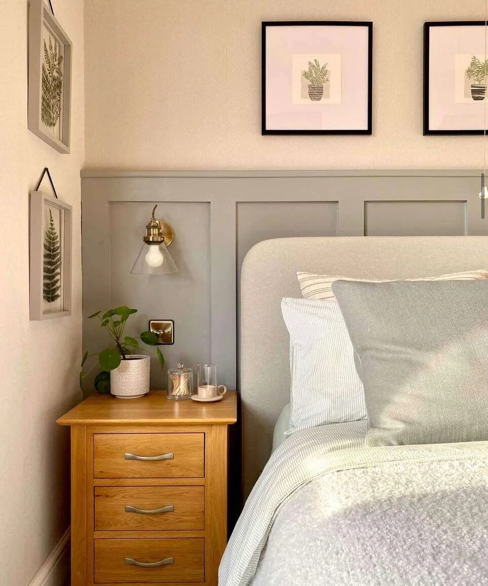 Wooden nightstand with a potted plant and glass jars