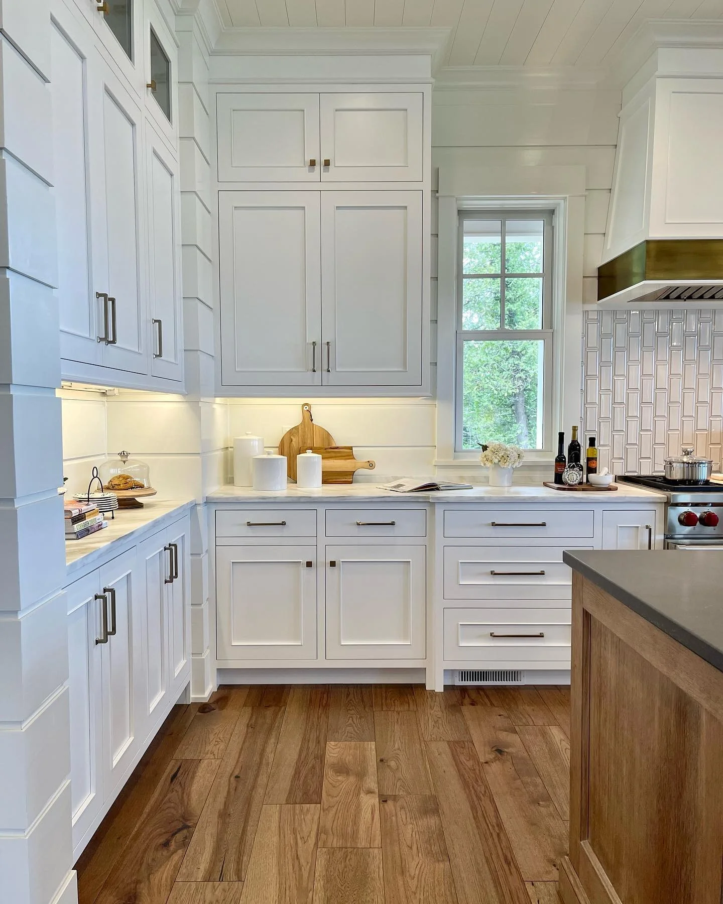 Shiplap Walls Frame a Brass Range Hood