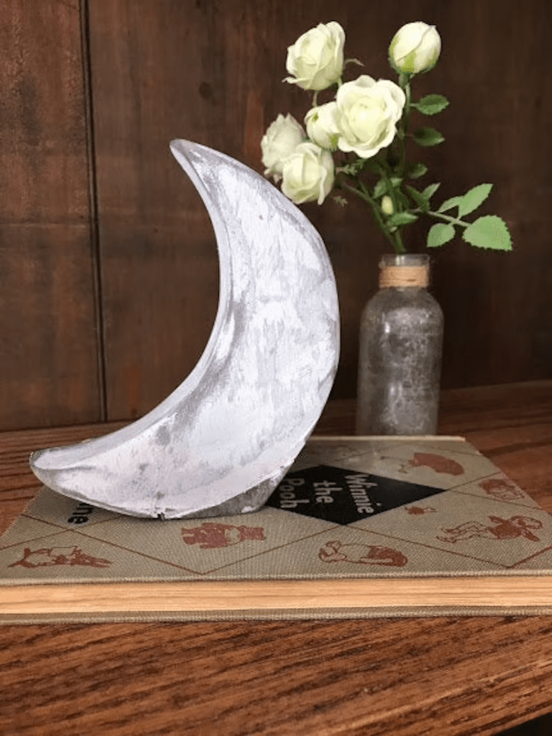 Place a Textured White Moon on a Book Stack