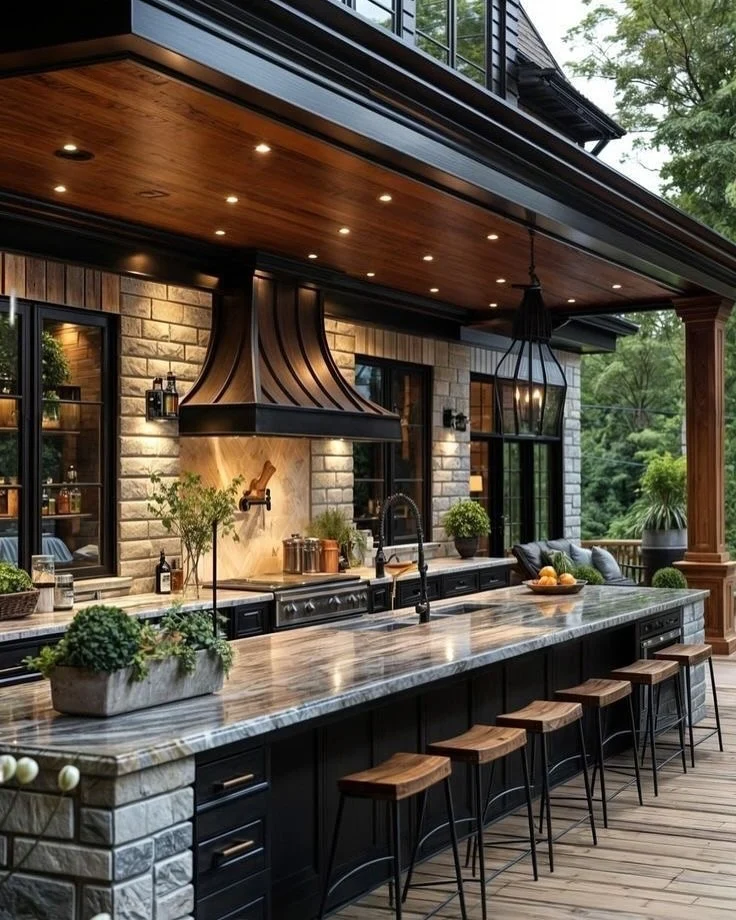 Sleek Black Cabinets Support a Dramatic Marble Countertop