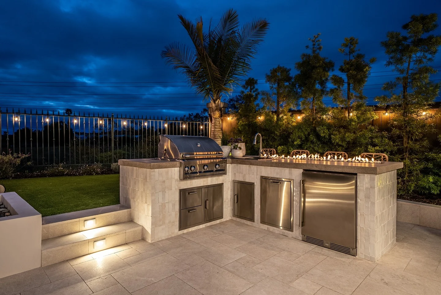 Integrated gas burners add ambiance to the outdoor kitchen counter
