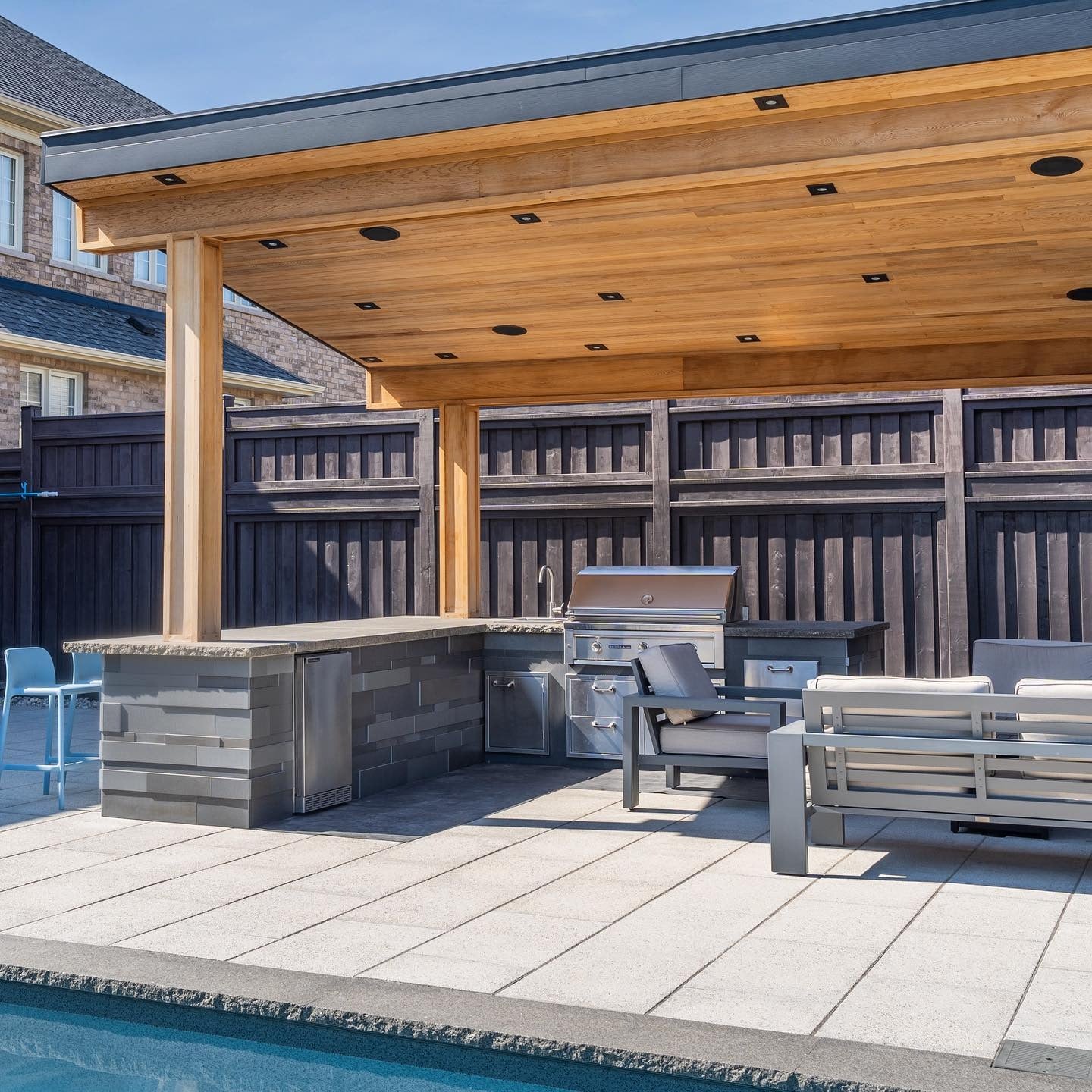 Textured Stacked Stone Creates a Grounded Bar Base