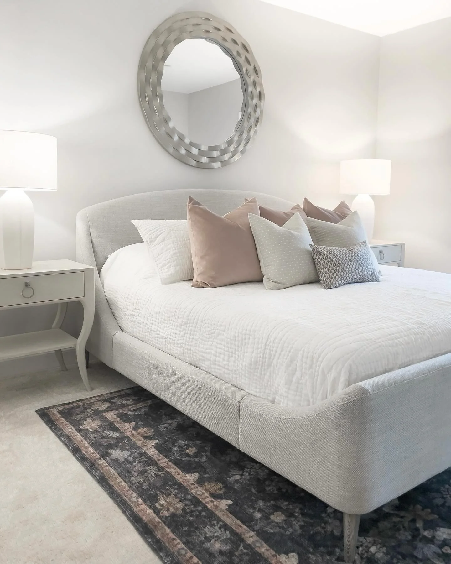 Textured Mirror Adds a Glamorous Focal Point Above the Bed