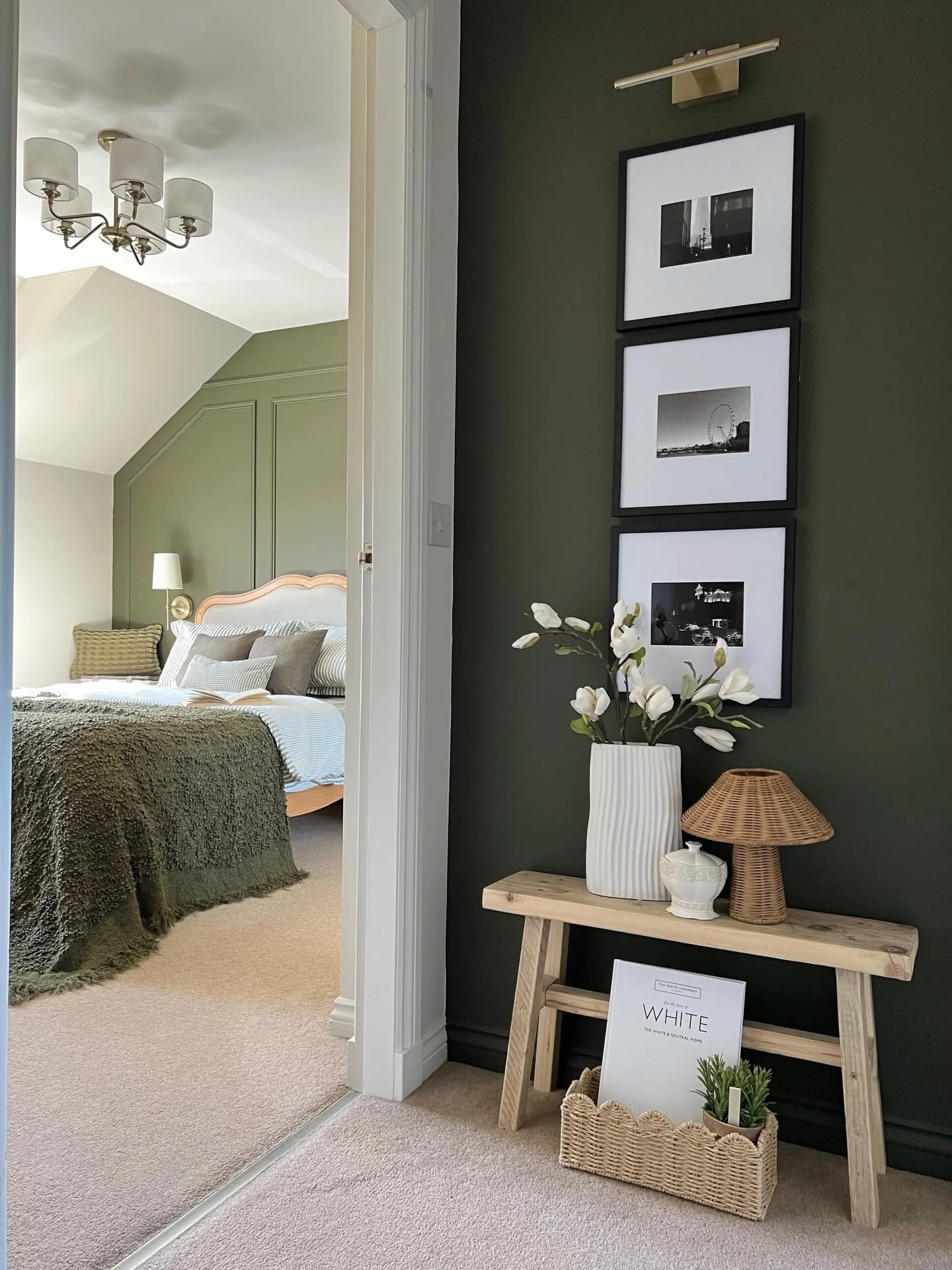 Stack Black-Framed Art Above a Rustic Bench Display