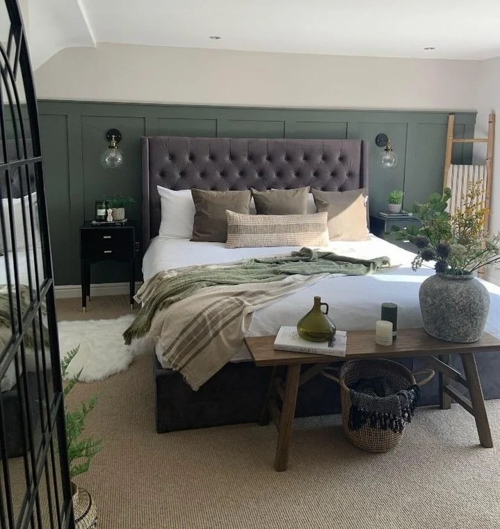 Deep Green Board and Batten Walls Frame a Tufted Headboard