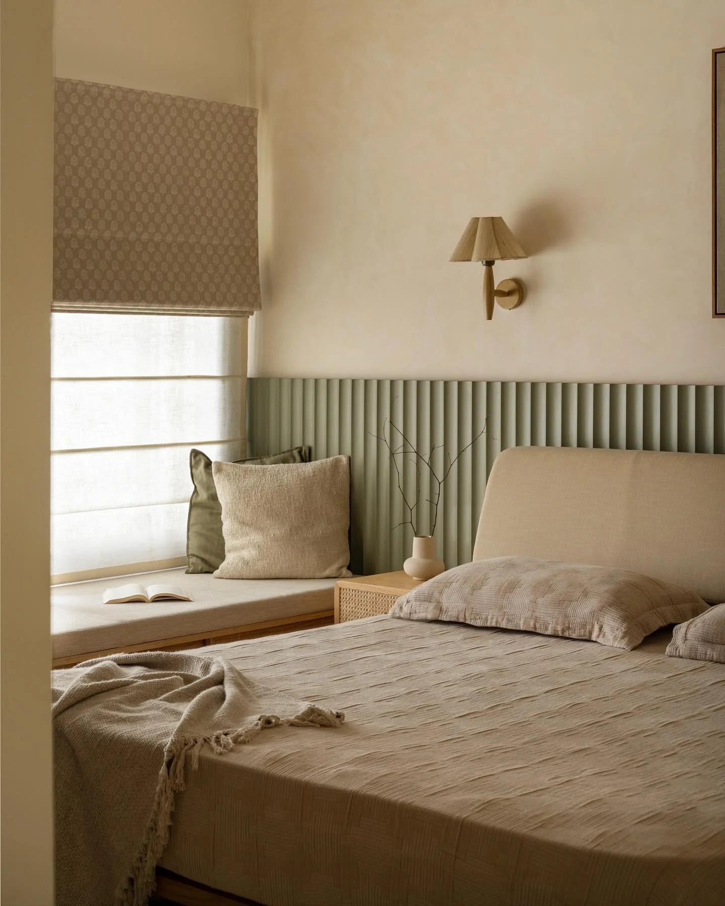 Fluted Green Wall Panel Behind a Upholstered Headboard