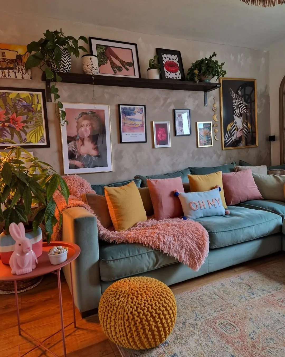 Eclectic Gallery Wall Mixes Art Styles Above Sofa