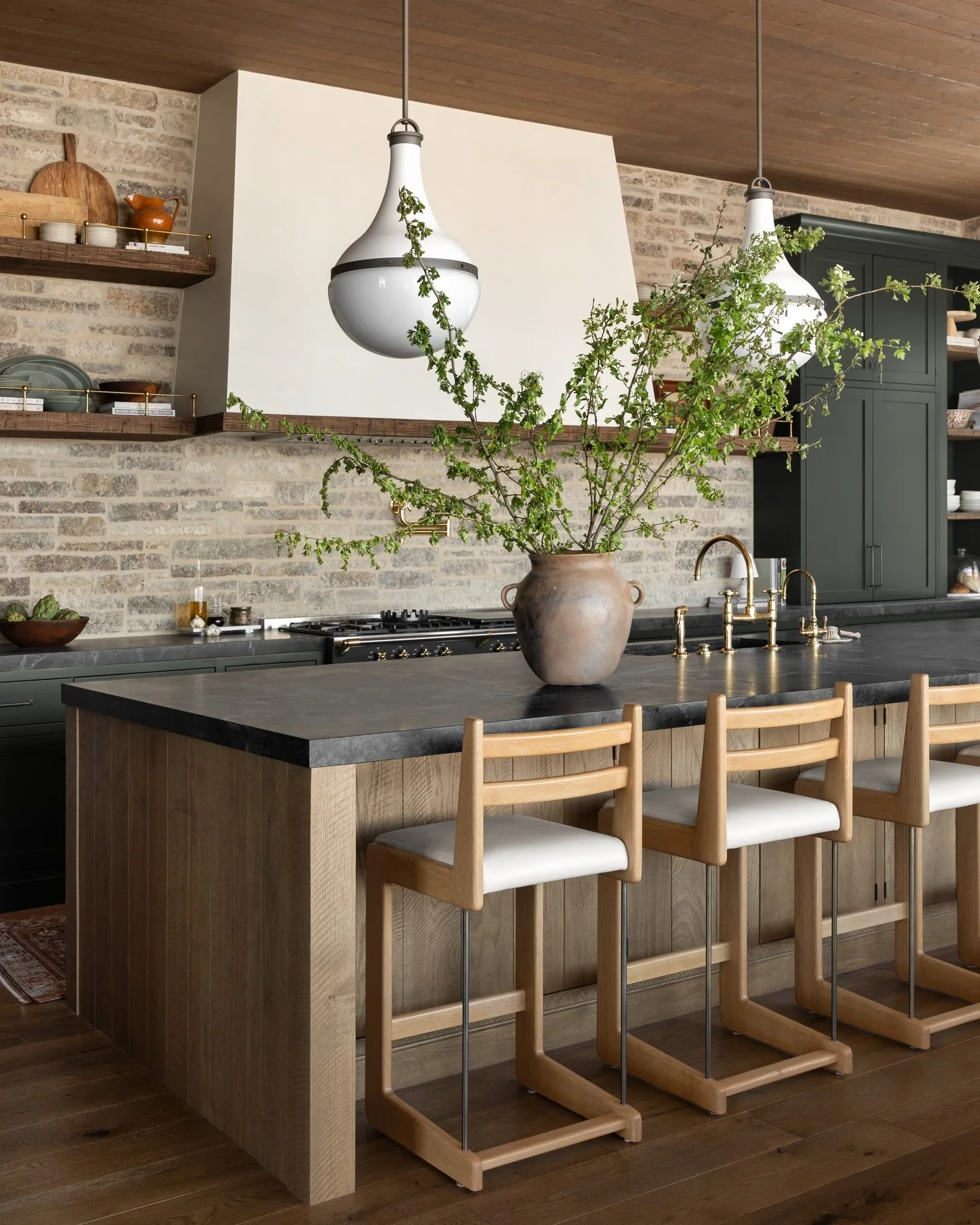 Oversized Ceramic Vase Holds Dramatic Greenery for a Natural Focal Point