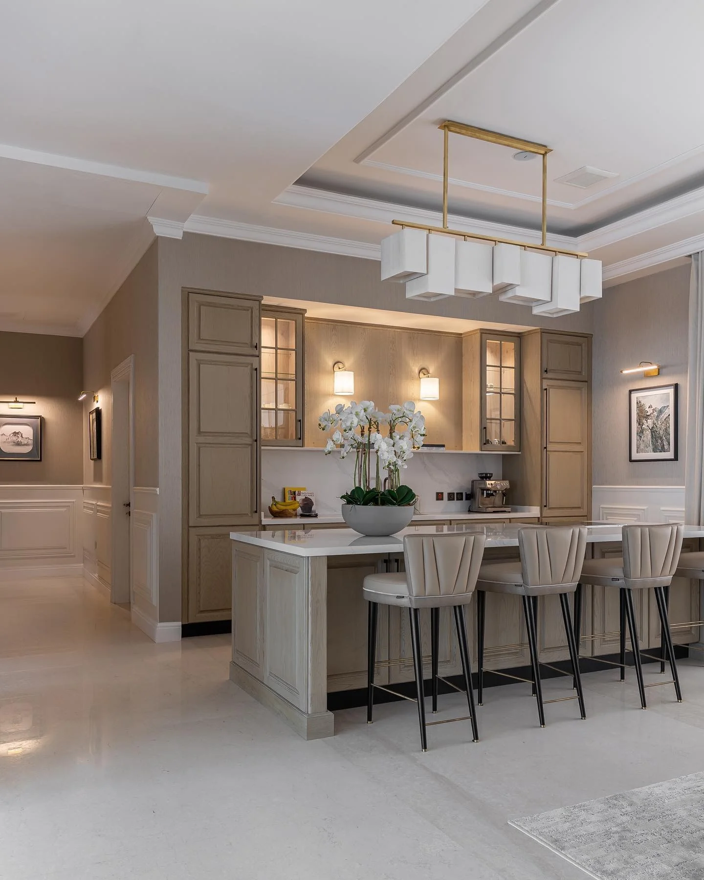 Sculptural White Shades Hang From a Brass Chandelier