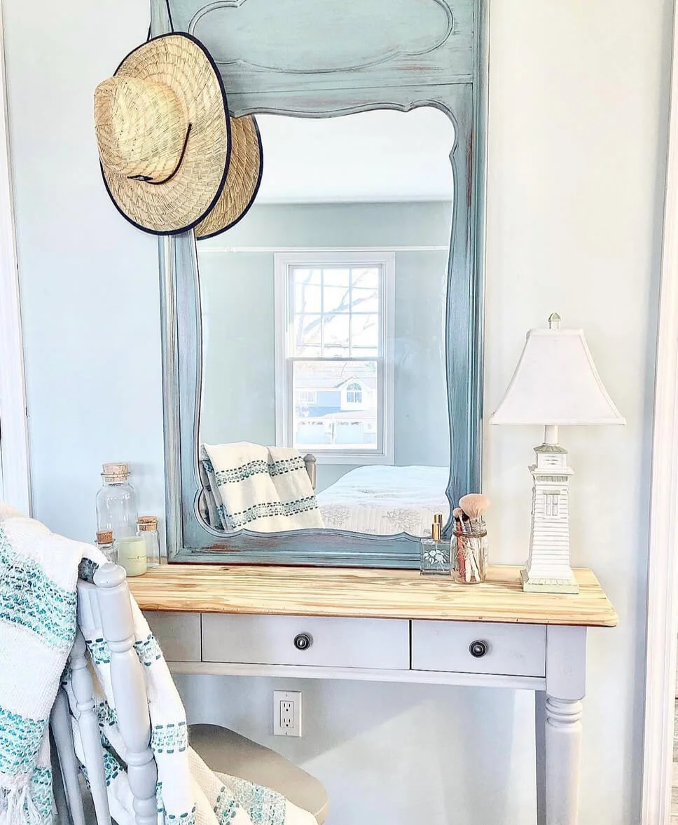 Distressed Blue Mirror Frames a Light Wood Vanity Top