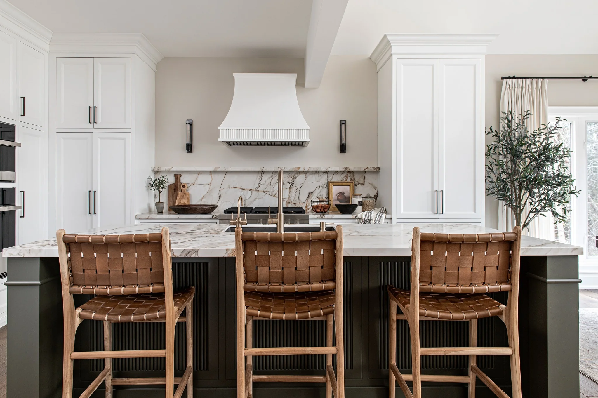 Woven Leather Stools Add Tactile Warmth to a Dark Island