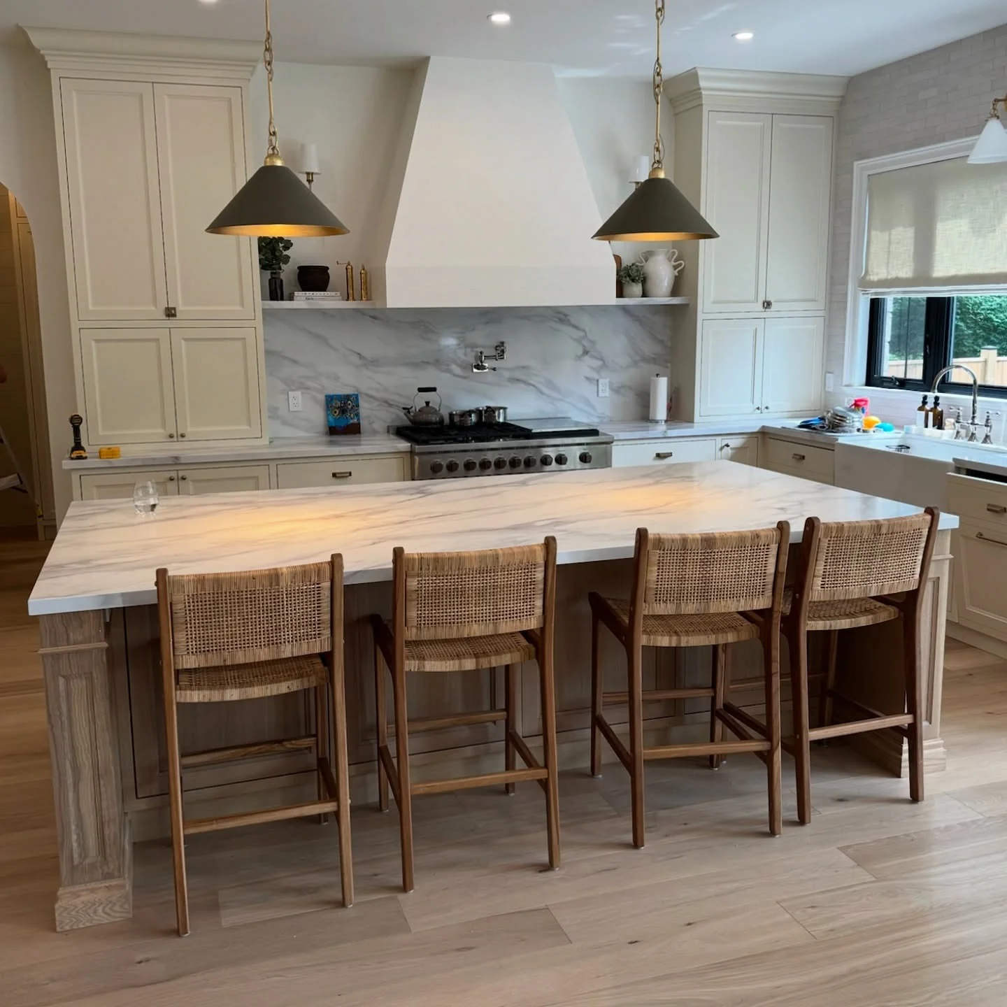 Cane-Back Stools Offer Airy Contrast to a Marble Island