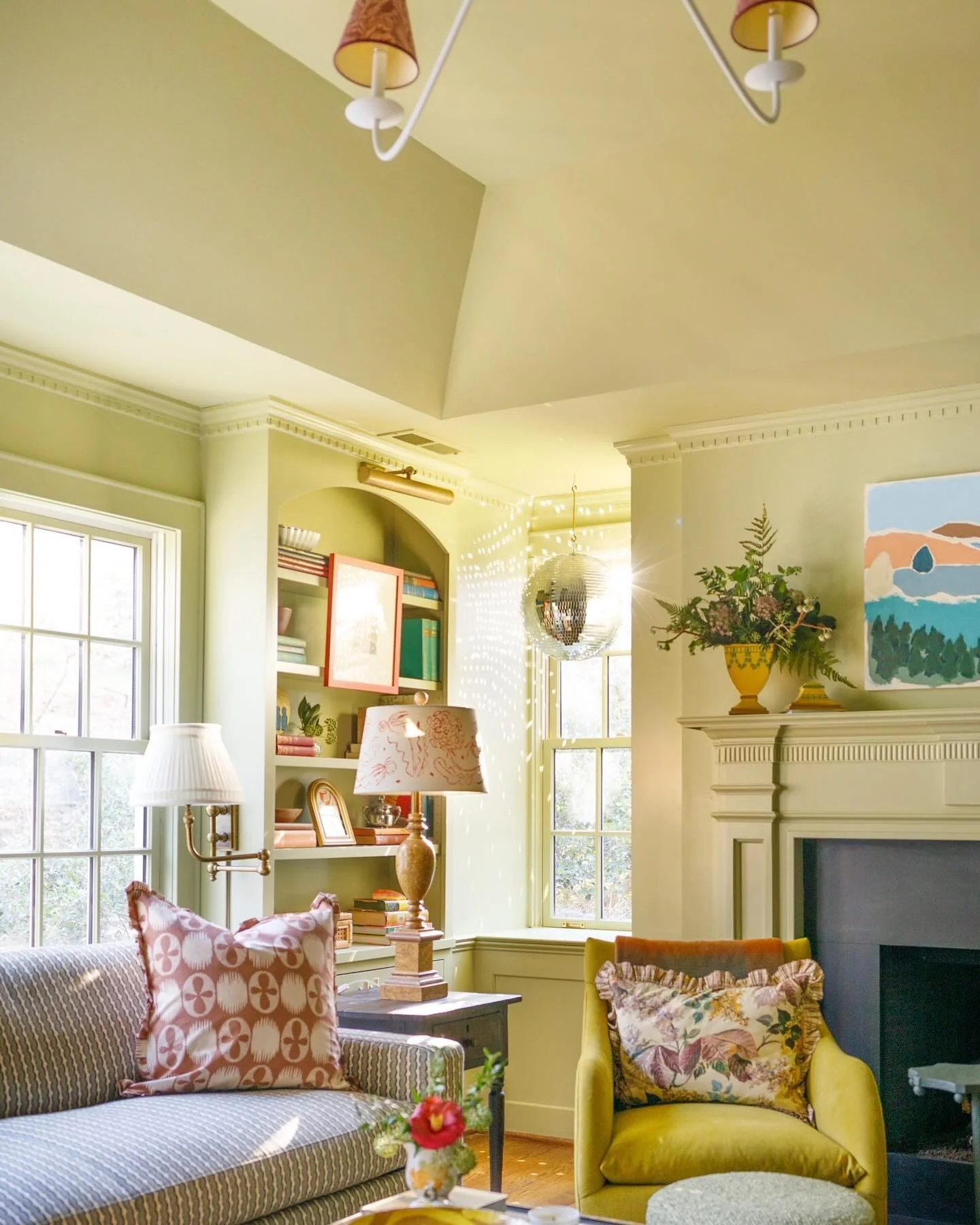 Disco ball adds playful sparkle to a yellow and gray room