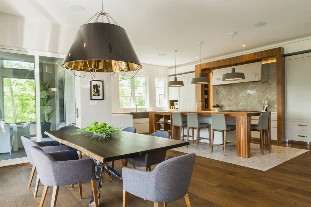 Warm Wood Plank Flooring Connects Open Kitchen and Dining Areas