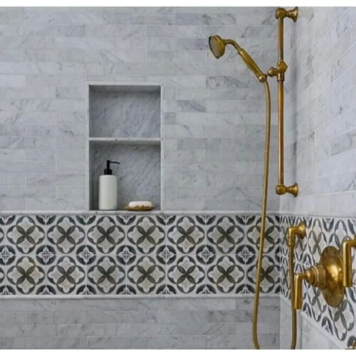 Patterned Tile Band Adds a Decorative Layer to Marble Shower Walls