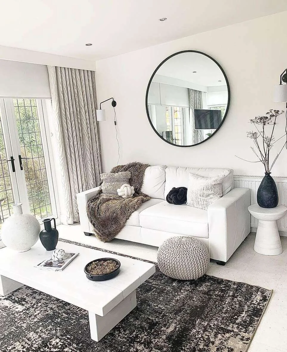 Oversized Round Mirror Frames Sofa and Fireplace