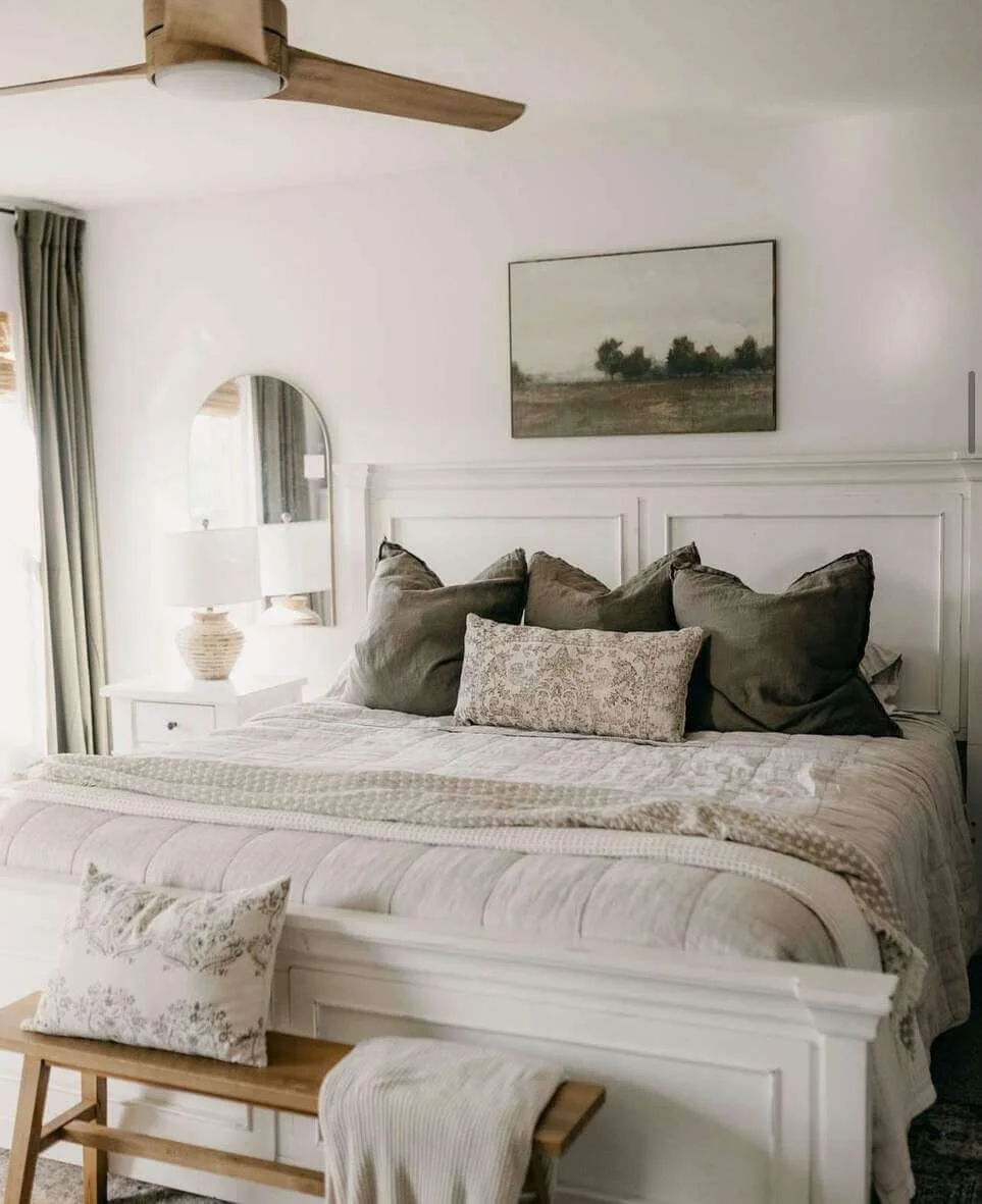 Arched Mirror Reflects Soft Light Above a Nightstand