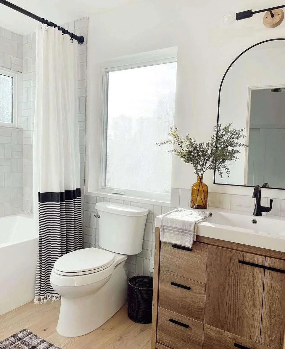Arched Mirror Adds a Dramatic Focal Point Above the Vanity