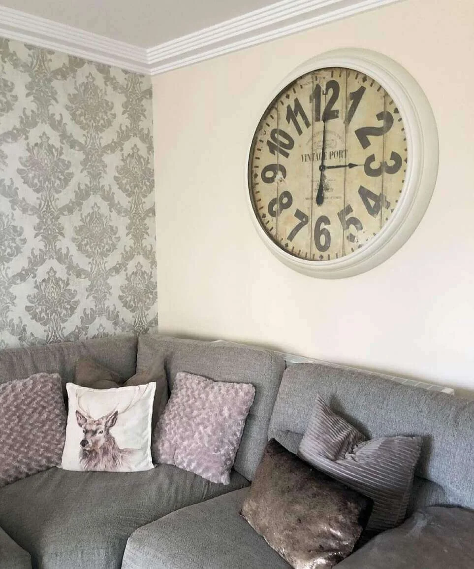 Oversized Vintage Clock Adds Rustic Charm Above Sofa