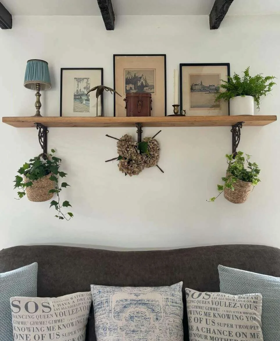 Wooden Shelf Holds A Curated Mix of Art and Decor