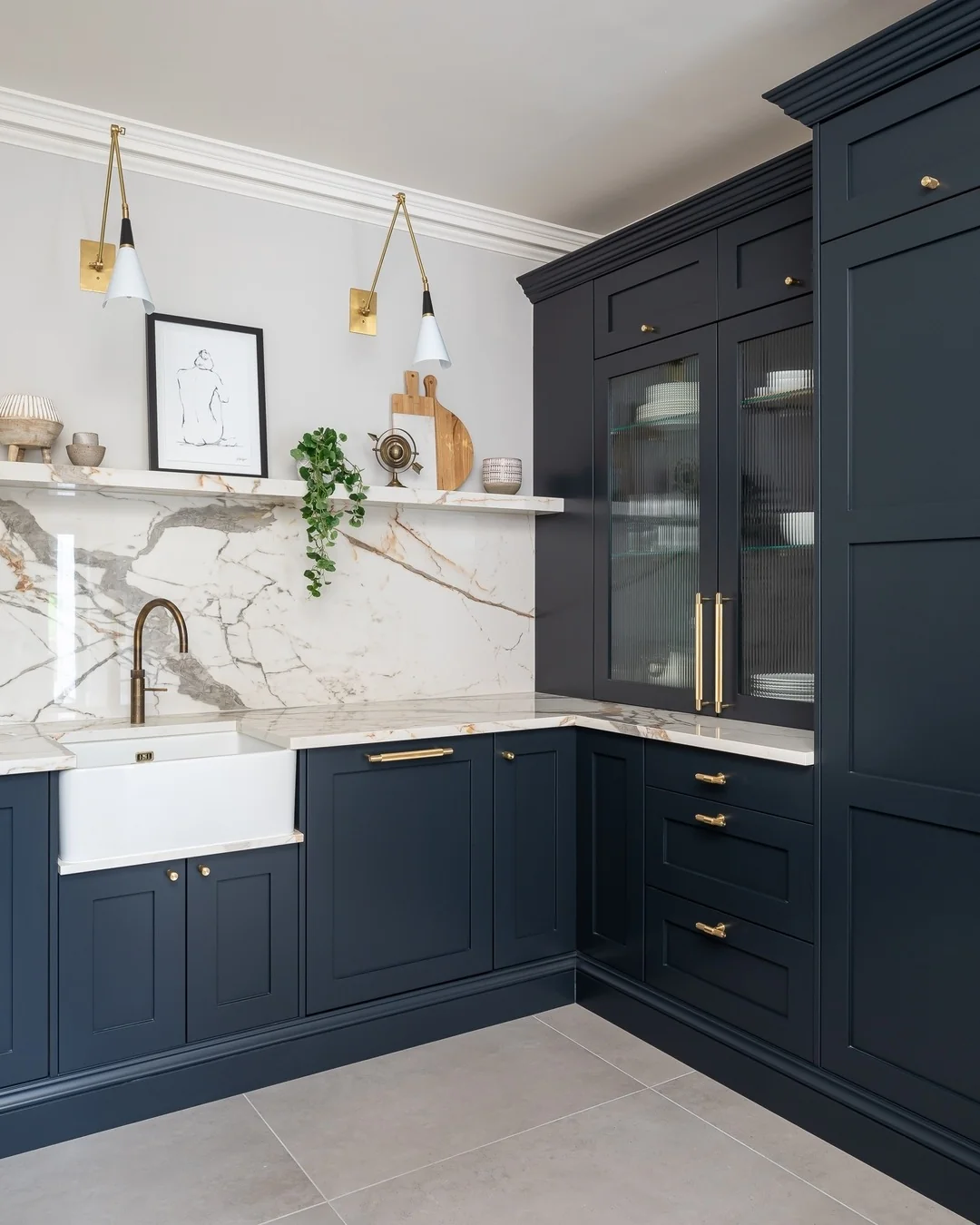 Dark Blue Cabinets Feature Ribbed Glass Doors for Soft Display