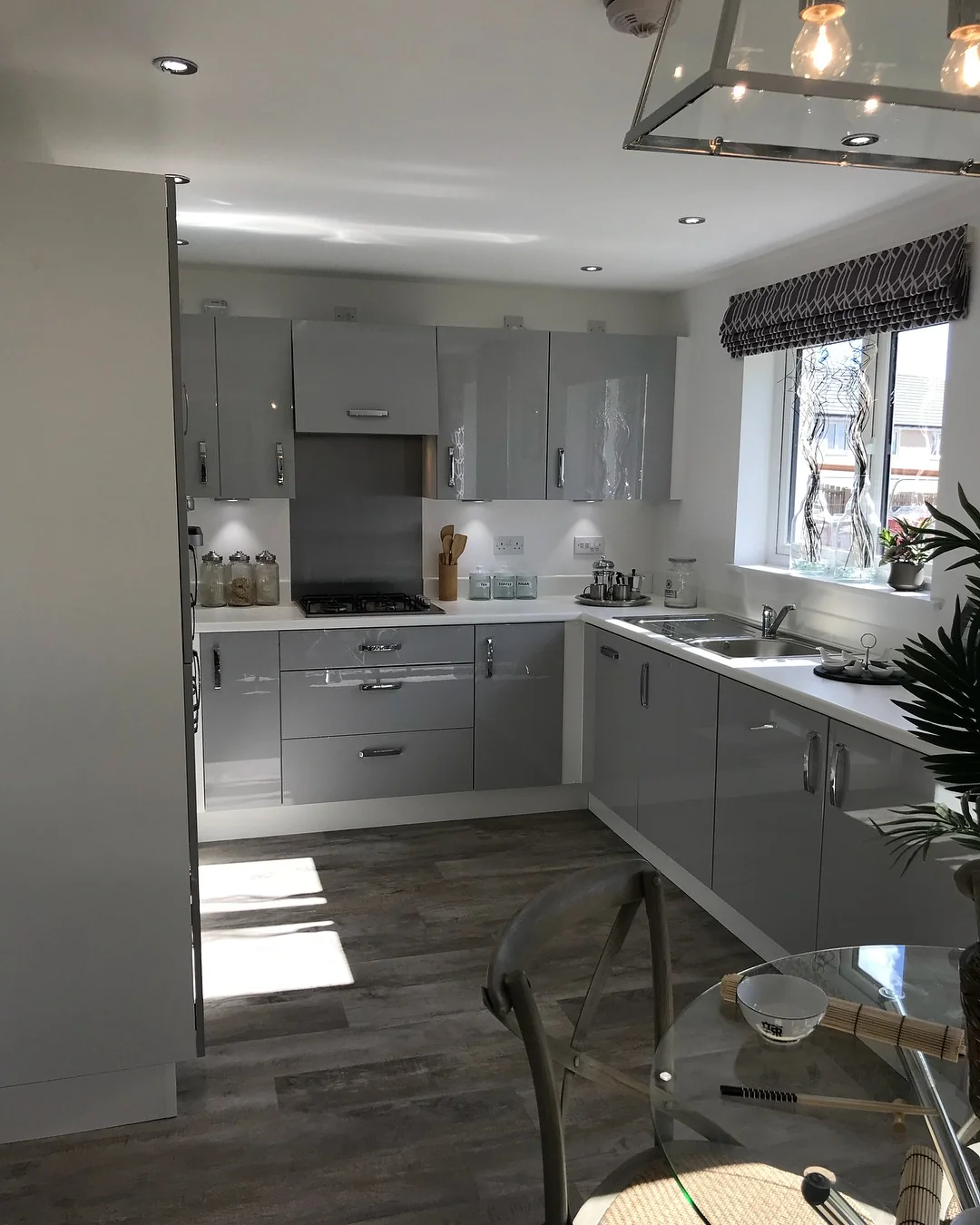 High-Gloss Grey Cabinets Create A Sleek, Reflective Kitchen Surface