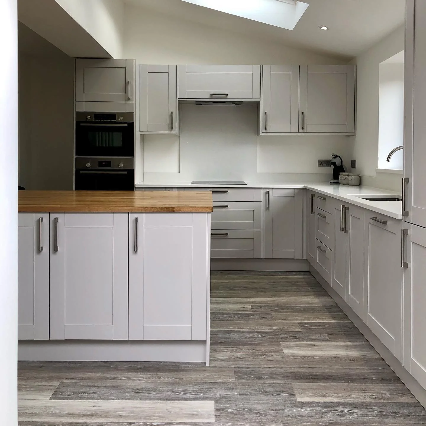 Wood-Look Flooring Adds Natural Texture to Grey Cabinets