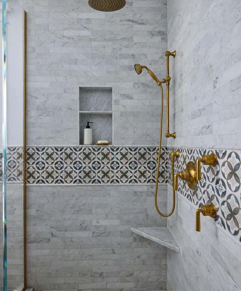 Decorative Band Tiles Add Pattern Between Marble Shower Walls