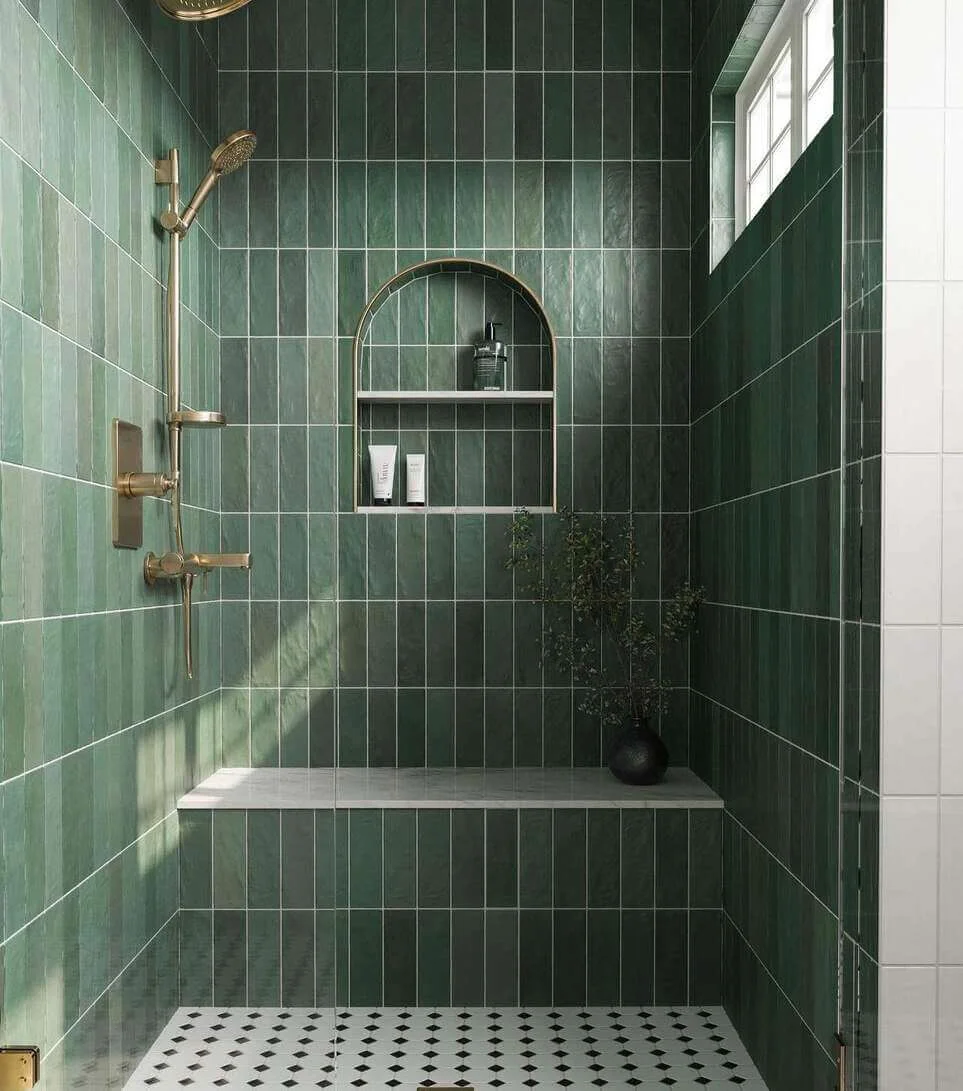 Arched Niche and Gold Fixtures Complement Deep Green Shower Tiles